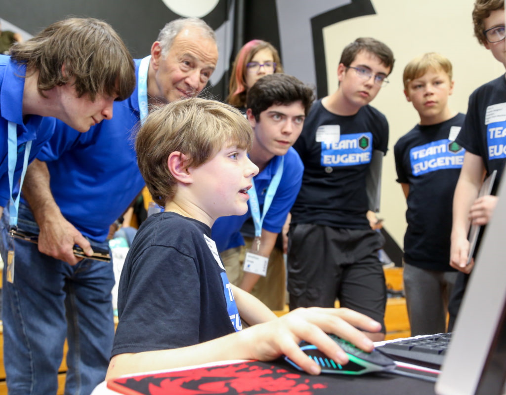 A student demonstrates his game to an audience.