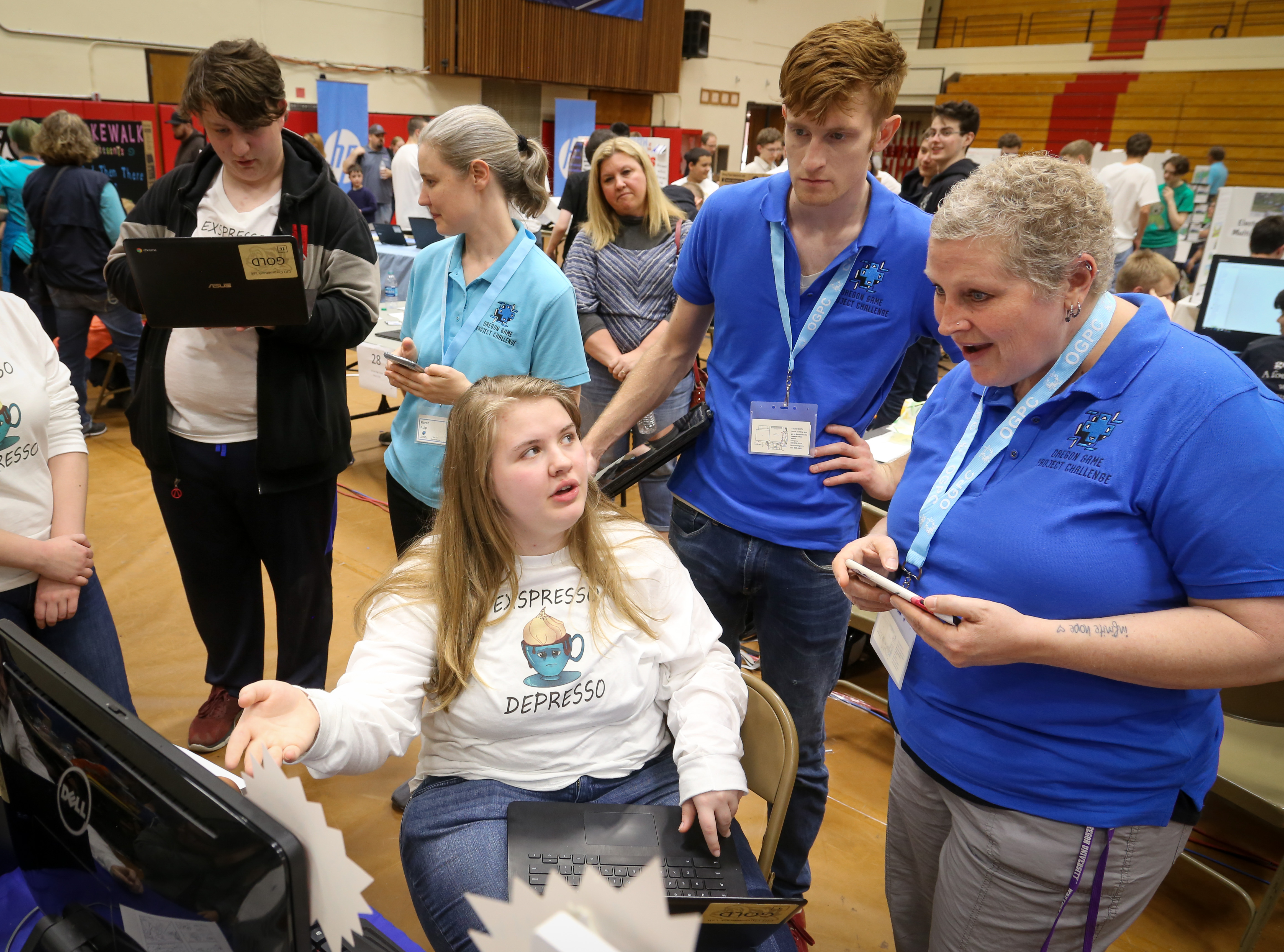 Judges talk to an OGPC participant about their project.